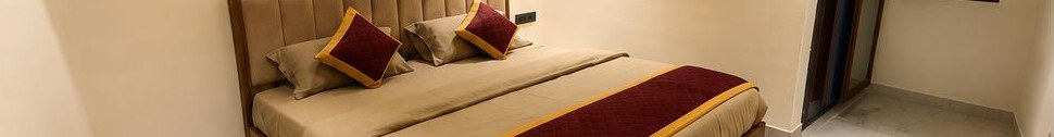 Wide guest room with layered bedding